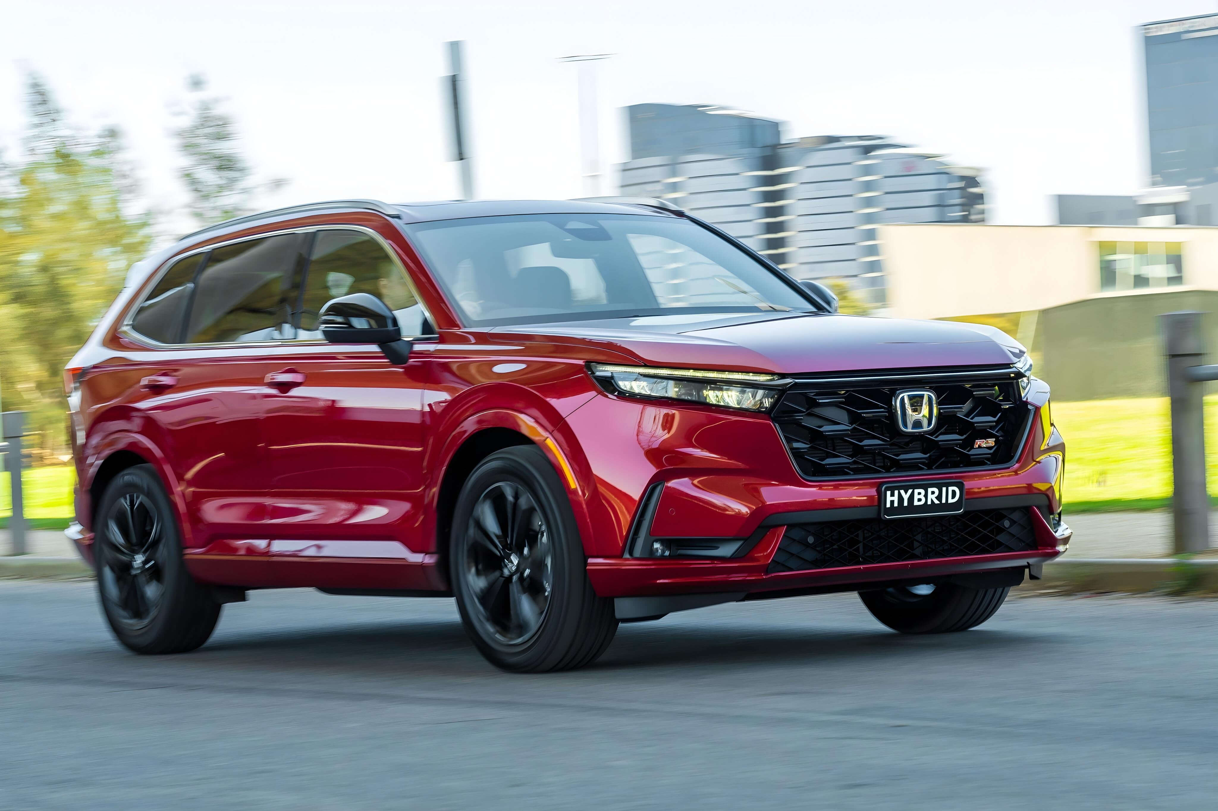 Красный Honda CR-V Hybrid в городе — гибридные модели Honda.